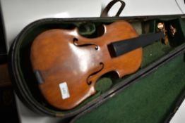 A traditional unlabelled violin, in need of repair with no tailpiece, bridge or strings etc, in hard