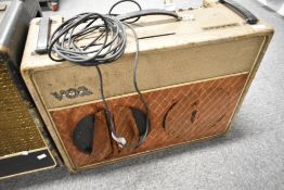 A 1963 Vox AC30 guitar amplifier having copper face plate, speakers being Celestion Bulldogs (one