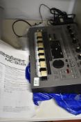 A Roland Groovebox, MC-303, with power supply and instructions