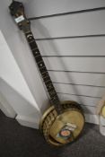 A traditional 4 string banjo, probably John Grey, badge worn