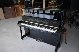 A modern upright piano, having ebonised case, Charles Howes & Son, Windermere model , serial