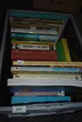 An assorted collection of reading material, titles including 'The Cottage Book', 'The World of