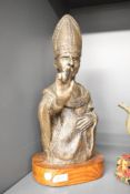 A 20th Century sculpture bust, depicting a papal figure, raised on an oval pine plinth, altogether