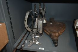 A 20th Century chromed metal horseshoe companion stand with irons, measuring 28cm high, and a pair