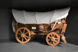 A 20th Century model of a covered wagon, measuring 45cm long