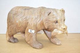A large late 20th century carved bear table top sculpture in the black forest style with salmon in