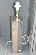 A heavy contemporary rectangular table lamp, the body fashioned from modern dense monochromatic