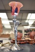 An attractive contemporary table lamp in the Art Nouveau style modelled as a maiden wearing a long