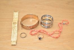 A gold plated engraved hinged bangle, along with a Rotary wristwatch, coral chip necklace, two rings
