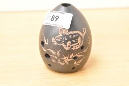A Chinese pottery egg-shaped Xun Ocarina flute musical instrument, incised decoration of a piglet
