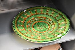A large vintage terracotta Spanish dish, beautifully decorated depicting rooster on a green glaze