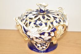 A late 19th/early 20th century pottery lidded tureen, with pierced cover, decorated throughout