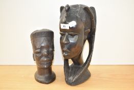 Two African carved-hardwood busts, the larger with elaborate braids, the smaller with incised
