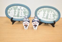 A pair of Wedgwood Jasperware style wall plaques in teal and white colour, depicting a scene of