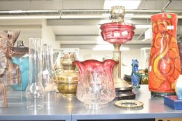 A Victorian brass and cranberry glass oil lamp, with cranberry tinted shade, two clear glass