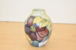 A Moorcroft Clematis pattern ovoid vase, paper label to the base, 9cm