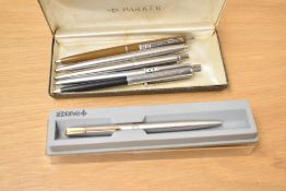 A boxed Eversharp rolled gold ballpoint pen and three various Parker ballpoint and rollerbsll pens