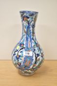 A 19th century pottery vase with iznik design, flared neck above ovoid body, decorated with trailing