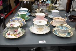 A selection of fine bone china cups and saucers, beautifully hand coloured with foliage and gild