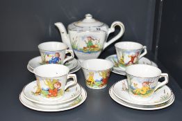 An early 20th century Shell ware children's tea set setting for four decorated with fairy tail tea