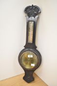 An early 20th century English Aneroid Barometer with mercury pressure index. Carved in oak wood with
