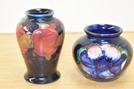 An early 20th century Moorcroft miniature pomegranate pattern vase, h9cm, sold alongside a Moorcroft