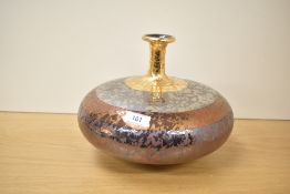 A contemporary art studio ceramic vase in metallic finish , 21cm.