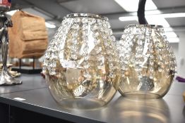 A set of three contemporary ceiling lights with cascading strands of crystal bead drops ascending