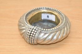An African white metal Manilla slave bracelet, repurposed as a dish with inserted brass liner/