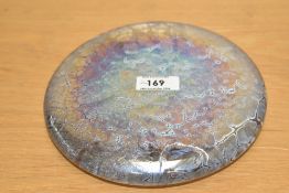 A mid century John Ditchfield 'glasform' irridescent paperweight of flattened circular form,