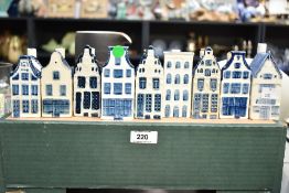 A collection of miniature Dutch blue and white Delft hand coloured ceramic replica houses, makers