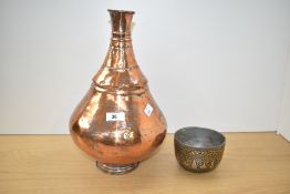 An early 20th century middle eastern copper belly vase, 35cm, alongside a finely hand crafted