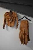 A mid-late Victorian young ladies two-piece skirt-suit, in a copper coloured fine wool, featuring