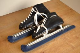 A pair of vintage Viking ice skates, in black leather with plastic blade caps still attached, size