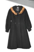 A vintage black wool coat, having a mink collar, and a fit and flare skirt, a little wear in places,