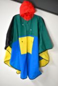 A 1960s Mary Quant rain poncho in primary colours red, yellow, blue and green, unused and in its