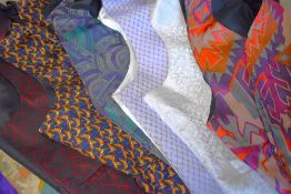 A quantity of mens waist coats in a variety of colours, patterns and fabrics, with a men's