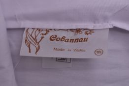 Four 1970s Cobannau white cotton blouses, from the Welsh factory known for the style, which closed