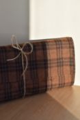 A bolt of 100% pure new wool, in warm brown tartan check, 3m long and 150cm (60 inches) wide.