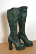 A pair of 1960s genuine leather forest green platform heel knee-high boots, size 5.