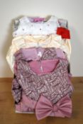 Four modern child's bridesmaid or occasion dresses, comprising two mauve satin and velvet styles,