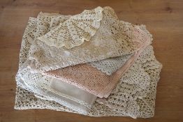 A collection of 20th century crochet, cotton and lace tableware in shades beige, off-white and blush