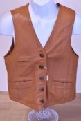 A 20th century waistcoat in tan genuine leather, having five tortoiseshell plastic buttons inset