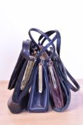 Five early to mid twentieth century leather handbags. A brown rib textured with short handle, 6x8.