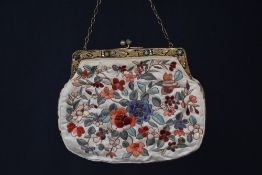 An early twentieth century ladies occasion bag or clutch purse, in cream silk, featuring eight