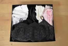 Seventeen pieces of ladies nightwear and slip skirts in either black, white, pale pink or cream, all