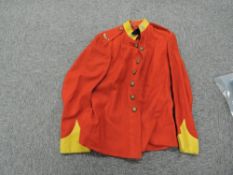 A 1913 Border Regiment Tunic with 9 buttons, 2 Border Tittles and 2 badges, with original label