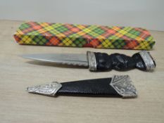 A Nowill of Sheffield Skean Dhu Boot Knife, with jewel set, carved hilt, with sheath. blade length