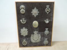 A framed board of Military Helmet Plates and Cap Badges, Duke of Lancaster's Own Yeomanry Helmet
