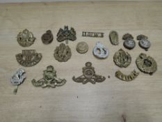 A small collection of Military Cap Badges and Shoulder Titles including RAF, RFC, Royal Artillery,